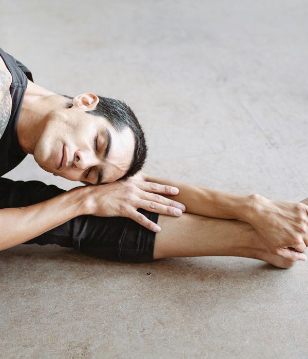 Man performing a controlled strength exercise in a calm studio environment.